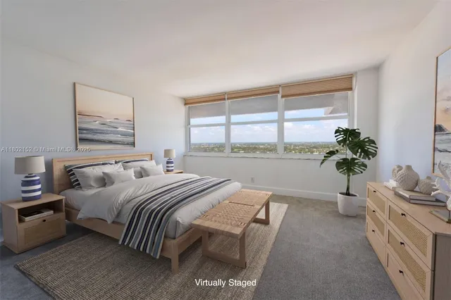 a bedroom with a large bed and a potted plant