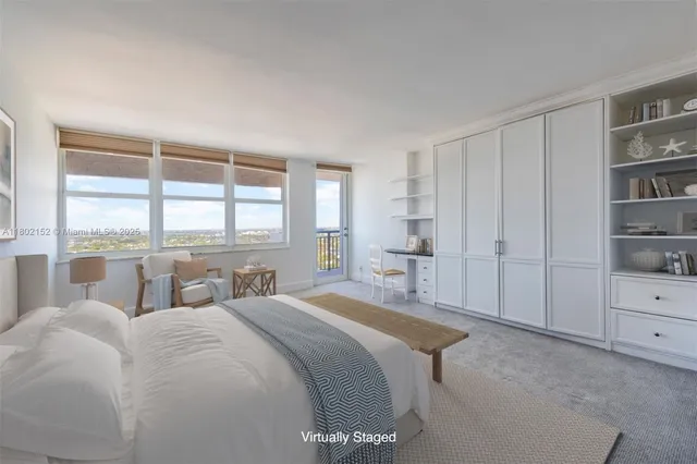 a bedroom with a bed and a large window