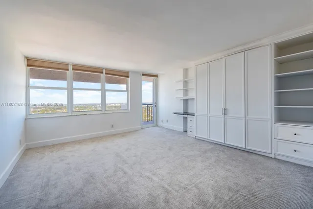 an empty room with a empty space and windows