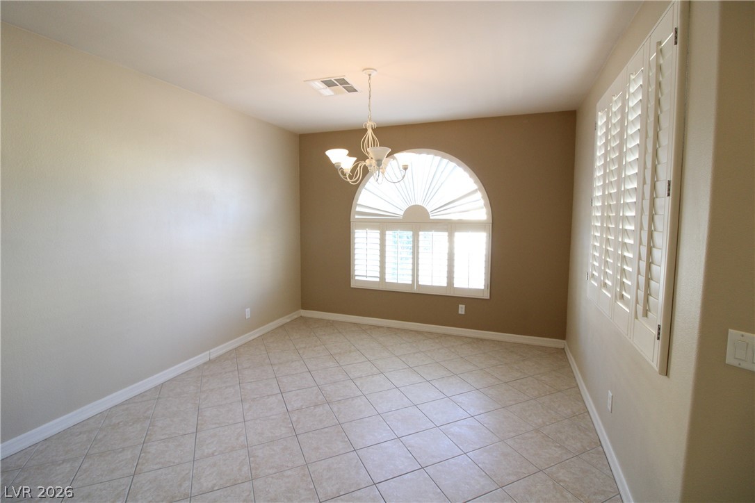 754 Rise Canyon Drive Henderson, NV 89052 - Photo 3 of 34 Natural illumination fills this room, highlighting the clean tile flooring and unique arched window design.