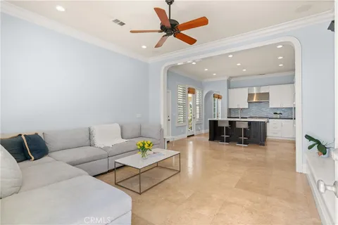 a living room with furniture and kitchen view