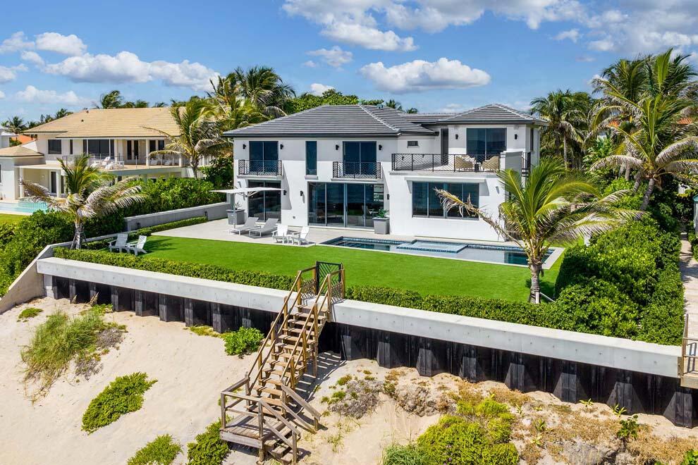 6029 Old Ocean Boulevard Ocean Ridge, FL 33435 - Photo 11 of 13 a front view of a house with a yard table and chairs