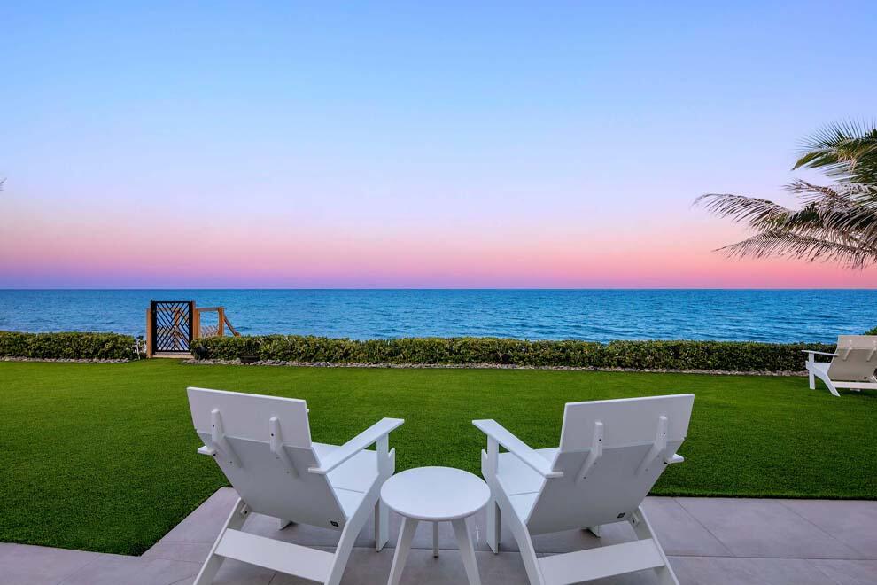 6029 Old Ocean Boulevard Ocean Ridge, FL 33435 - Photo 3 of 13 a view of a patio with lawn chairs under an umbrella