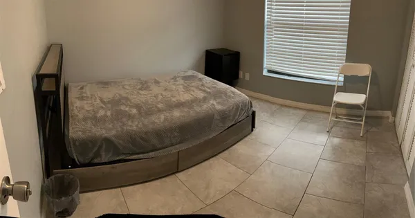 a bedroom with a bed and chair