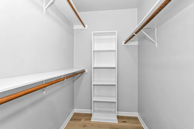 a view of walk in closet with empty racks
