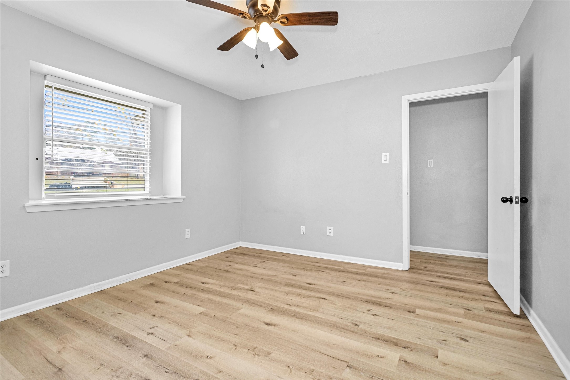 4655 Old Anderson Lane Conroe, TX 77304 - Photo 19 of 23 a view of an empty room with wooden floor and a window