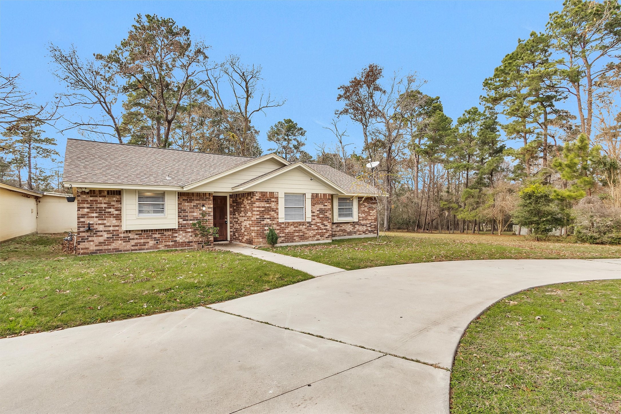 4655 Old Anderson Lane Conroe, TX 77304 - Photo 2 of 23 a view of a white house with a yard and potted plants
