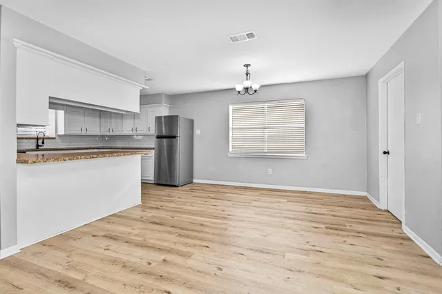 a view of a kitchen with a sink dishwasher and a refrigerator