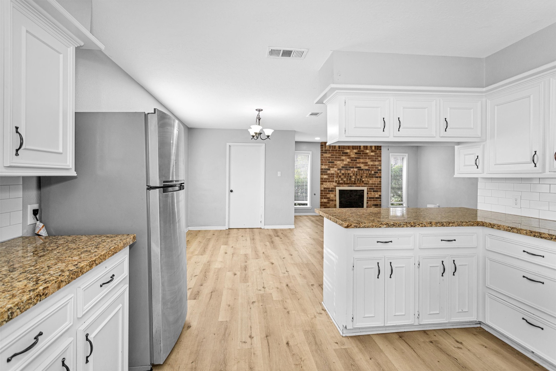 4655 Old Anderson Lane Conroe, TX 77304 - Photo 8 of 23 a kitchen with kitchen island granite countertop a sink and refrigerator