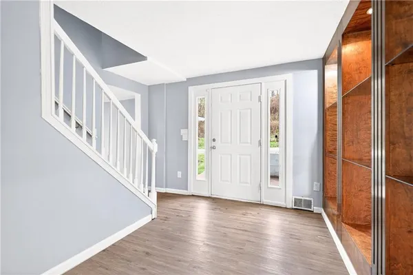 a view of an entryway with wooden floor