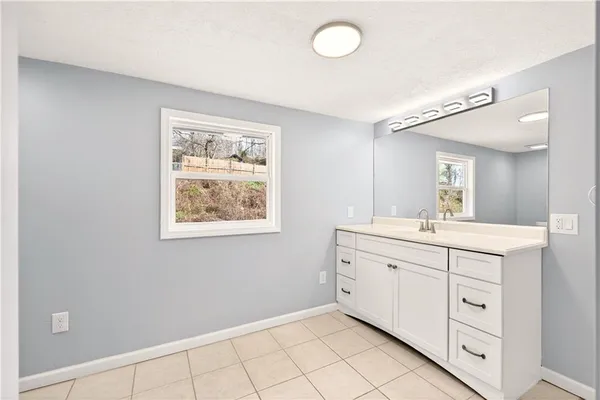 a bathroom with a sink vanity and mirror