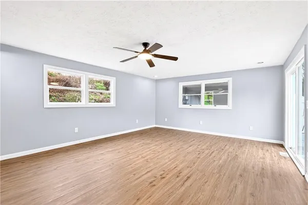 wooden floor in an empty room with a window