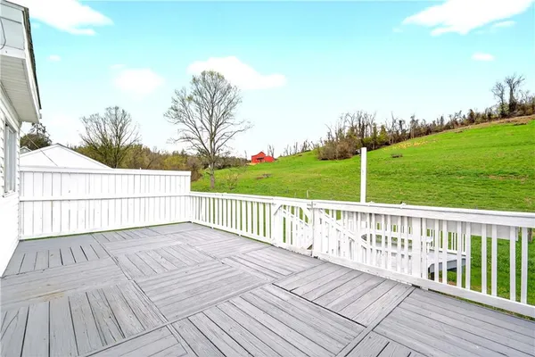 a view of a balcony with wooden floor