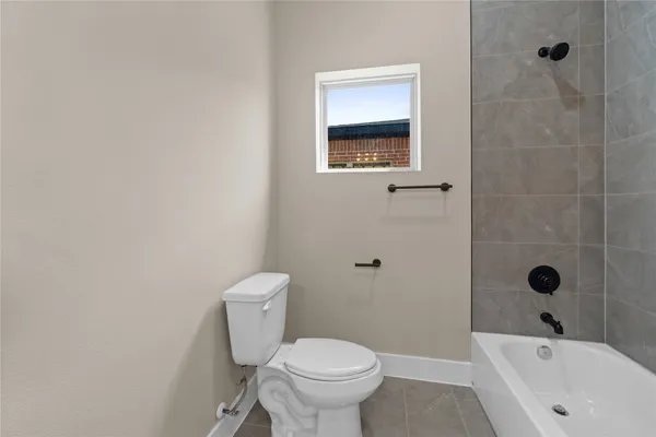 a bathroom with a toilet sink and shower
