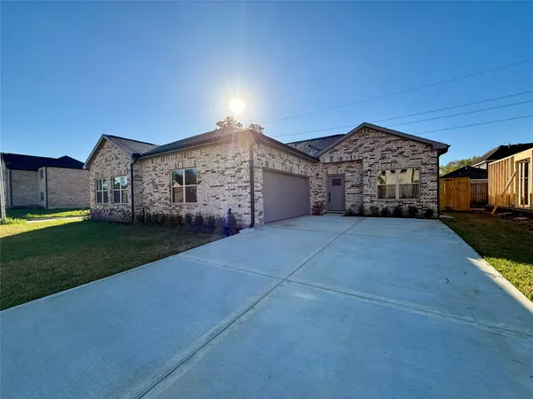 a view of house with yard and a wooden fence
