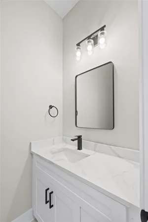 a bathroom with a sink vanity and a mirror