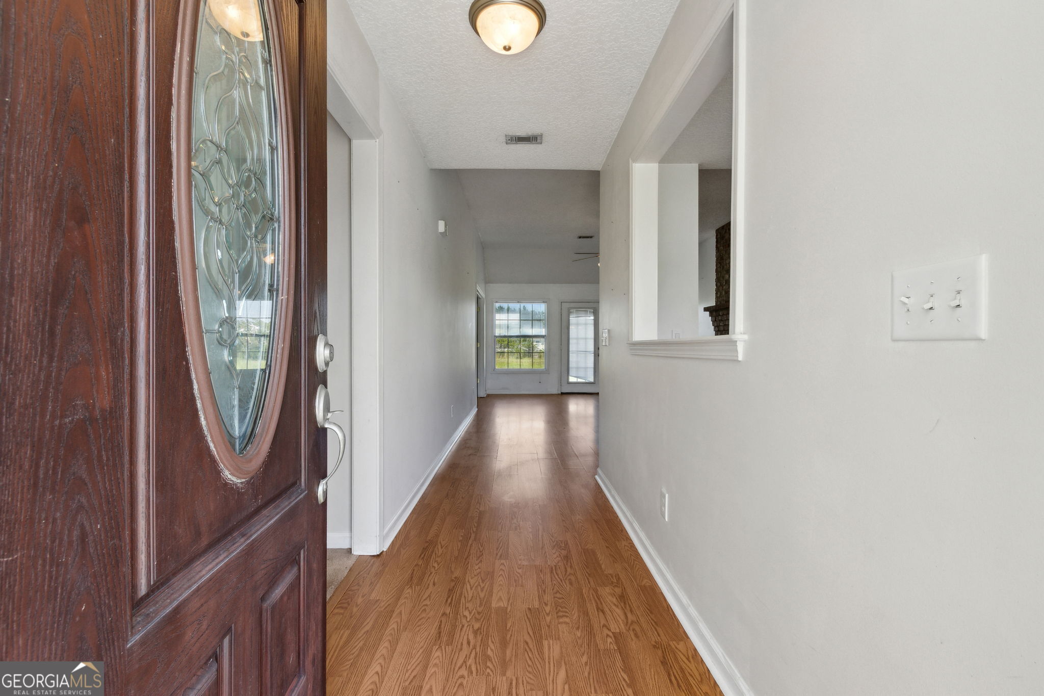 77 Thoroughbred Road Woodbine, GA 31569 - Photo 11 of 73 a view of a hallway with wooden floor and staircase