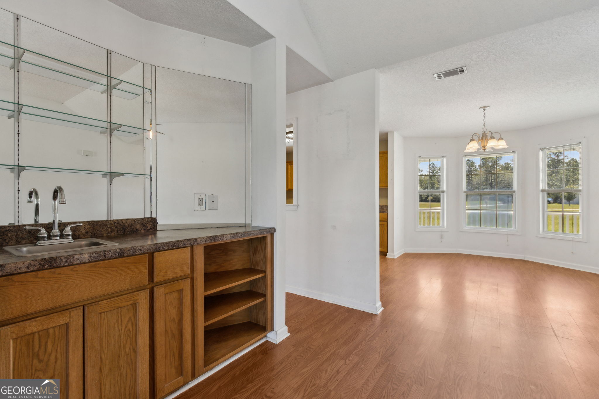 77 Thoroughbred Road Woodbine, GA 31569 - Photo 17 of 73 a kitchen with granite countertop white cabinets and wooden floor