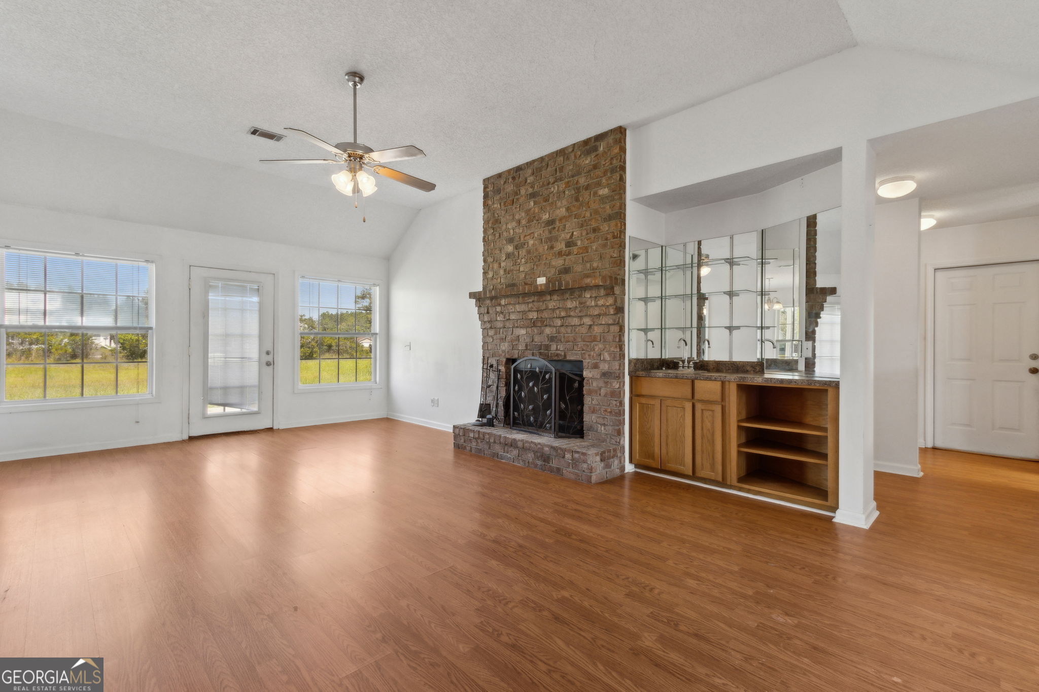 77 Thoroughbred Road Woodbine, GA 31569 - Photo 18 of 73 an empty room with a fireplace and wooden floor