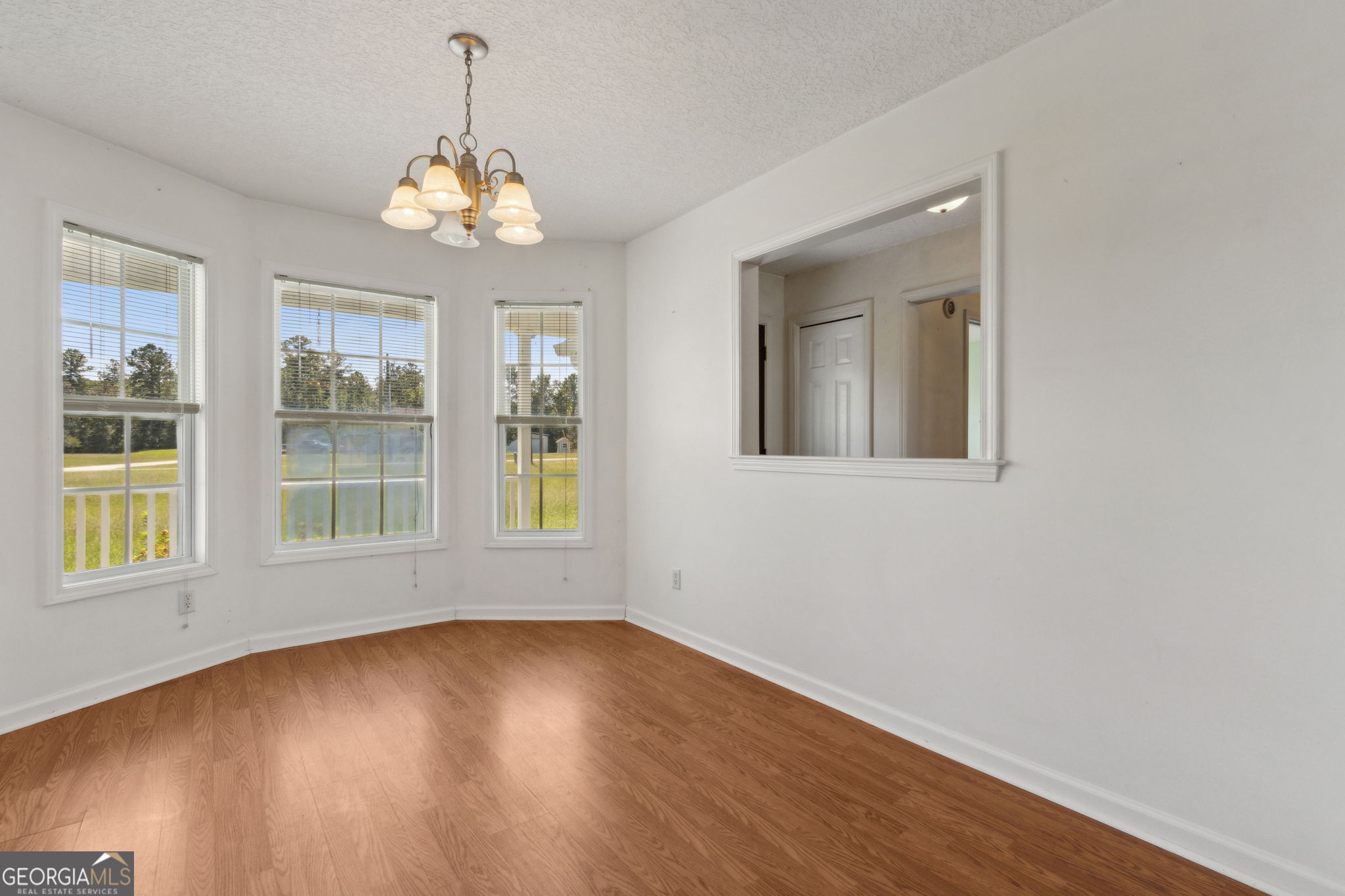 77 Thoroughbred Road Woodbine, GA 31569 - Photo 23 of 73 an empty room with wooden floor and windows