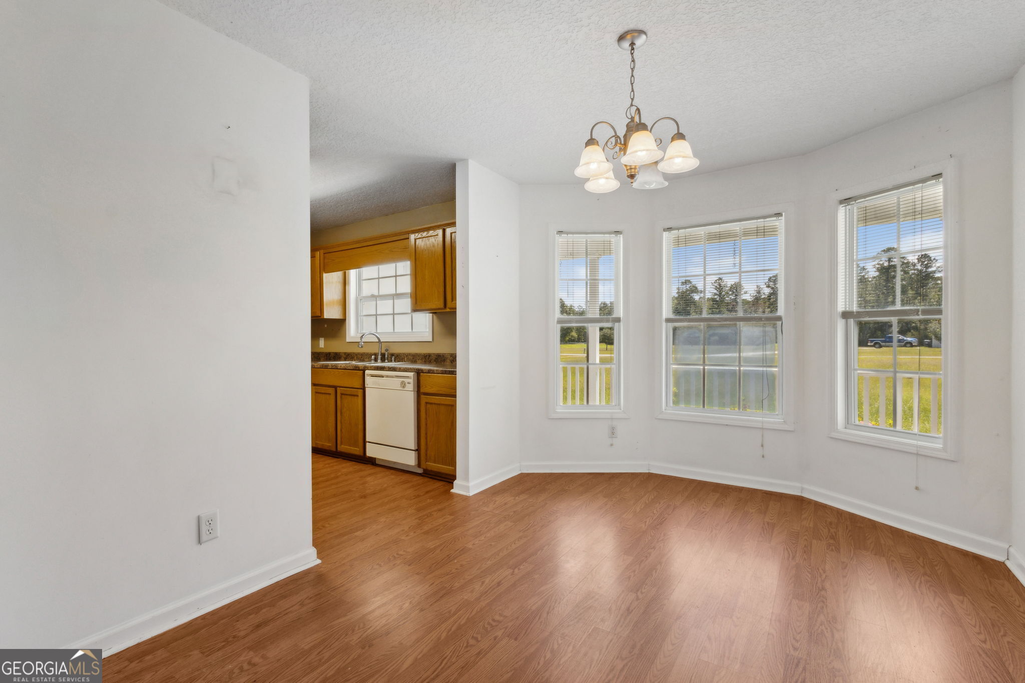 77 Thoroughbred Road Woodbine, GA 31569 - Photo 26 of 73 a view of an empty room with a window and wooden floor