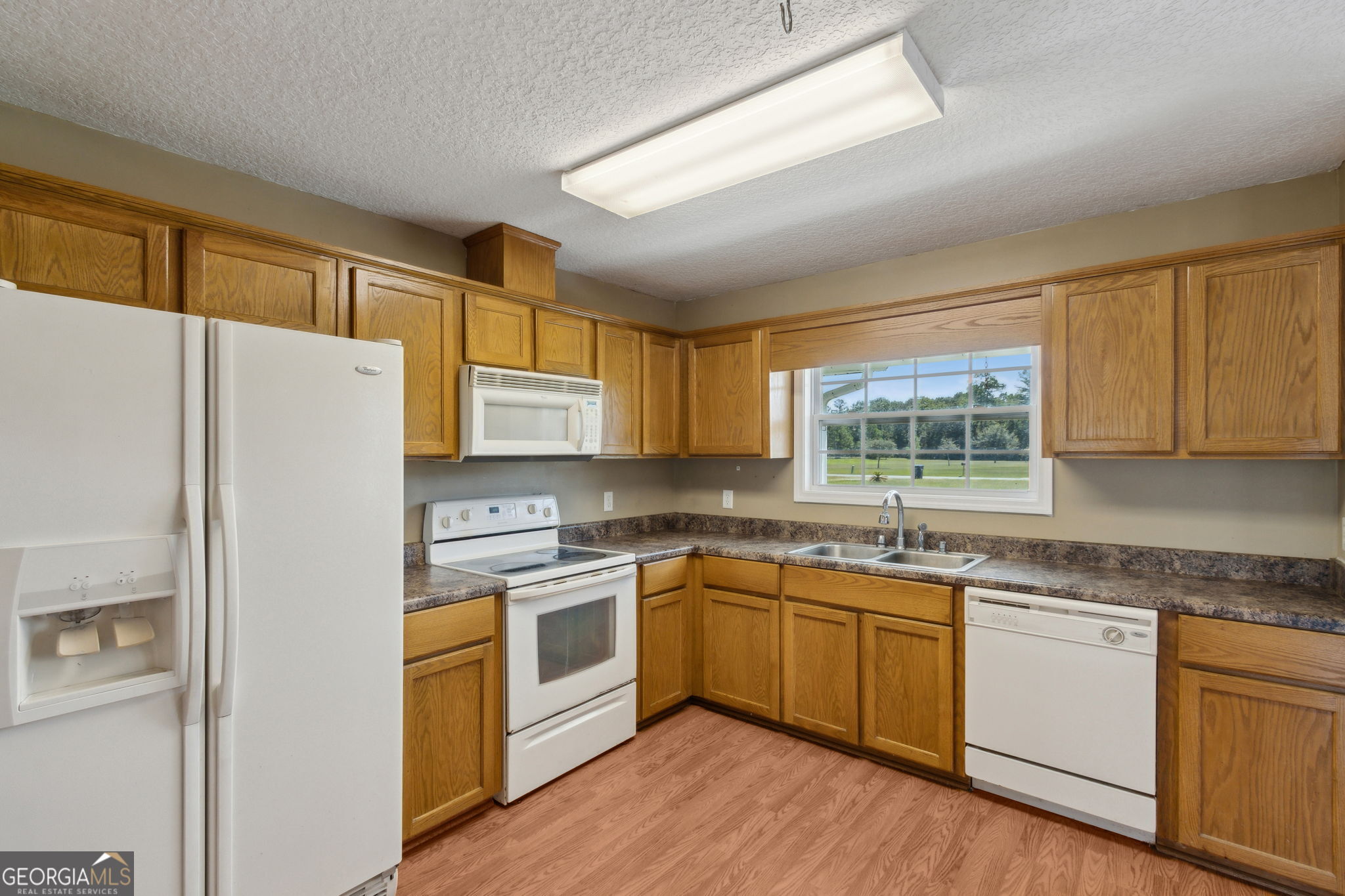 77 Thoroughbred Road Woodbine, GA 31569 - Photo 30 of 73 a kitchen with a white cabinets and white appliances