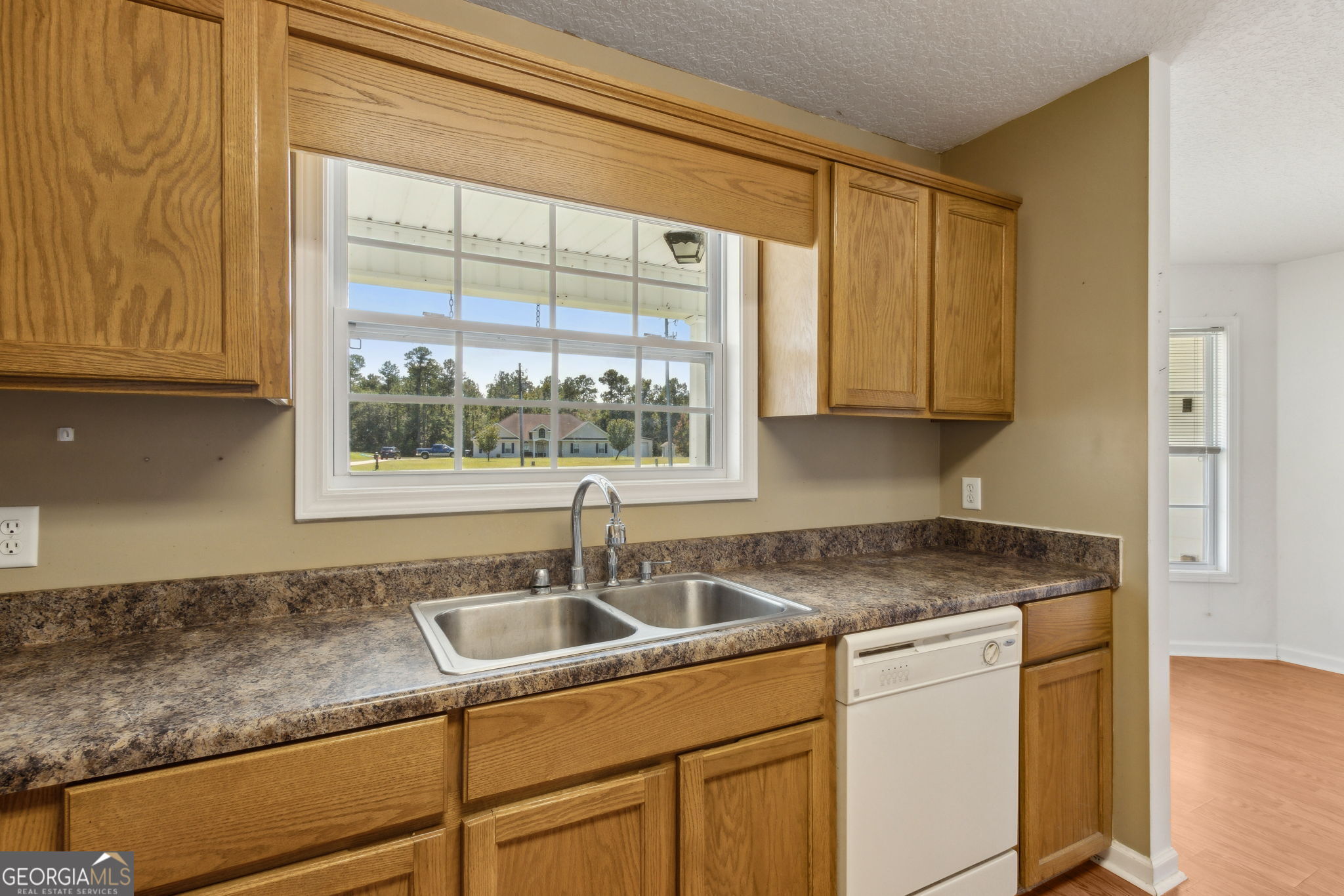 77 Thoroughbred Road Woodbine, GA 31569 - Photo 31 of 73 a kitchen with stainless steel appliances granite countertop a sink and a white cabinets next to a window