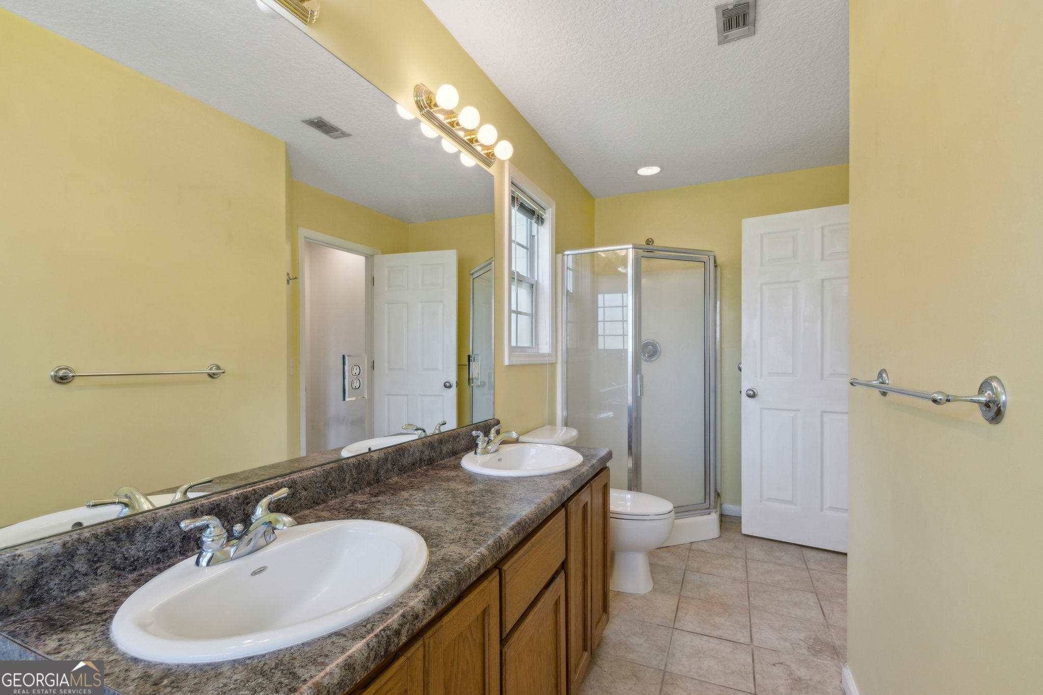 77 Thoroughbred Road Woodbine, GA 31569 - Photo 39 of 73 a bathroom with a granite countertop sink a toilet a mirror and shower