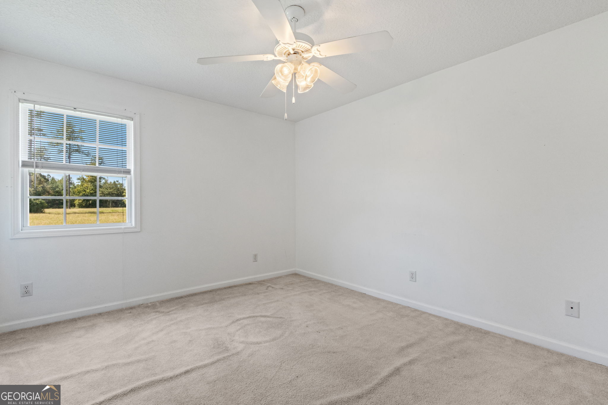 77 Thoroughbred Road Woodbine, GA 31569 - Photo 46 of 73 an empty room with a chandelier fan and windows
