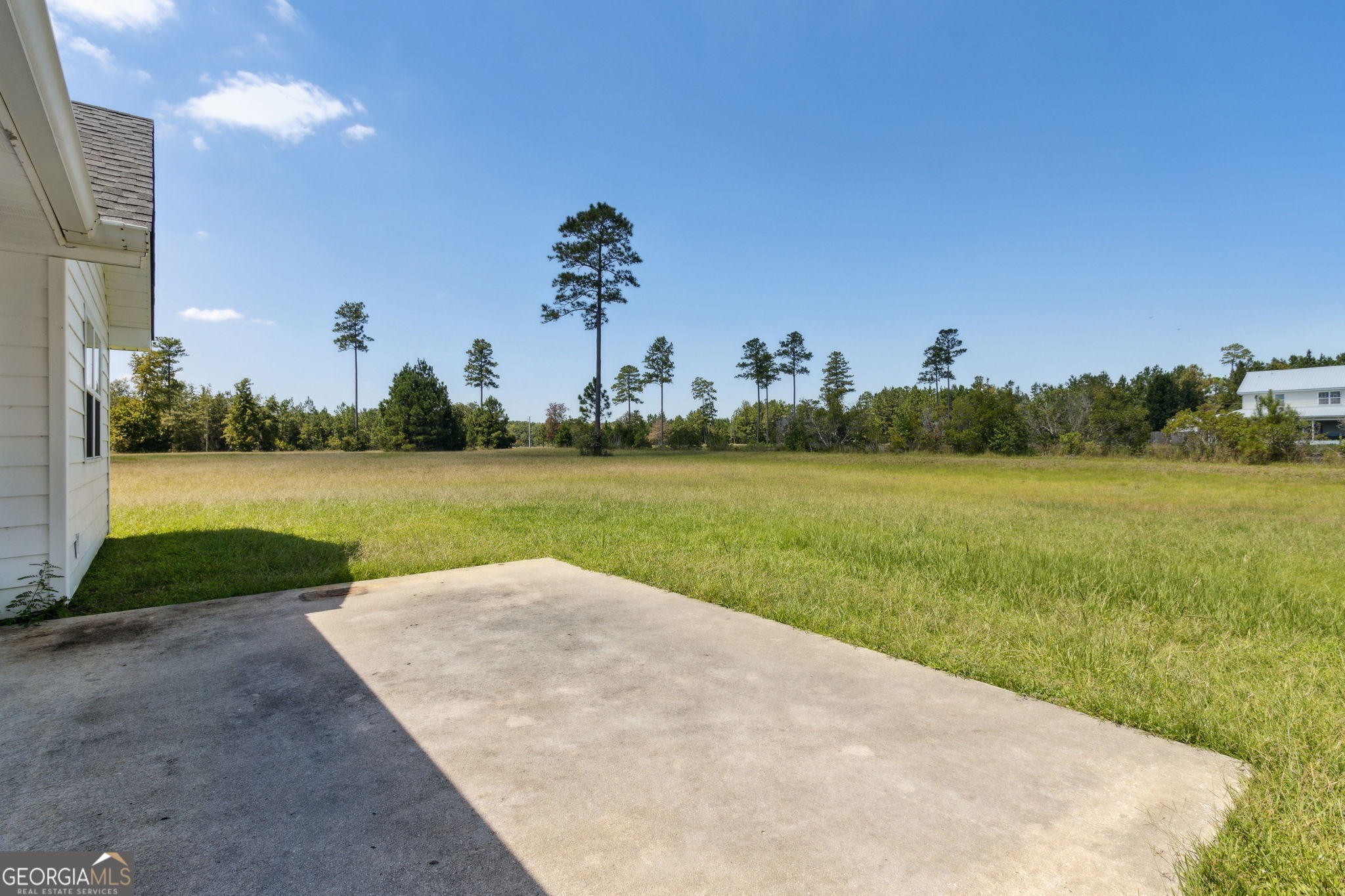 77 Thoroughbred Road Woodbine, GA 31569 - Photo 50 of 73 a view of a water with a big yard and a large building in the background