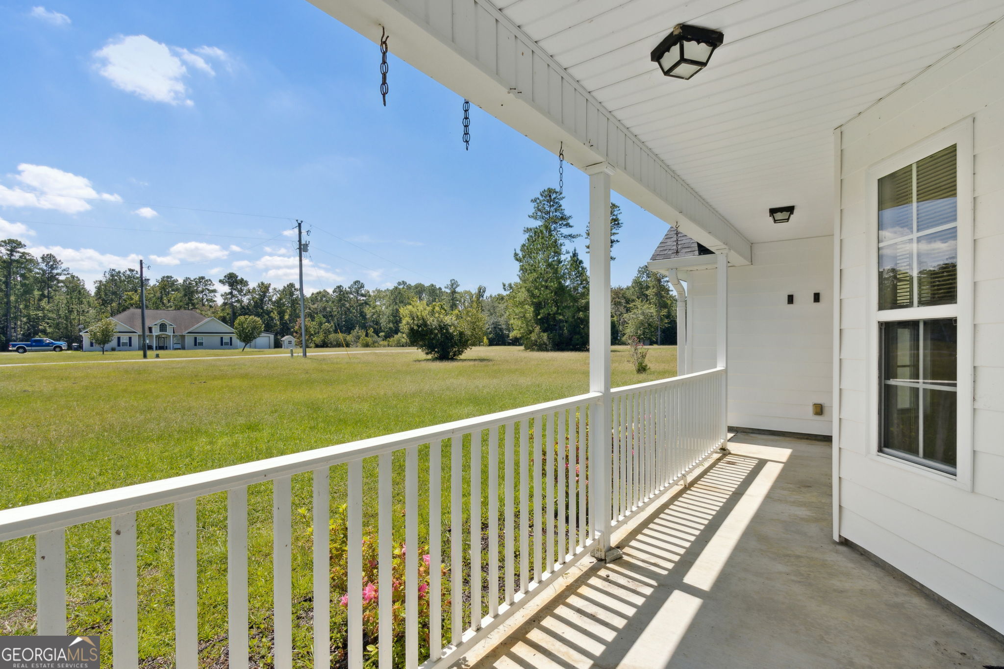 77 Thoroughbred Road Woodbine, GA 31569 - Photo 10 of 73 a view of a two chair in the balcony with wooden floor