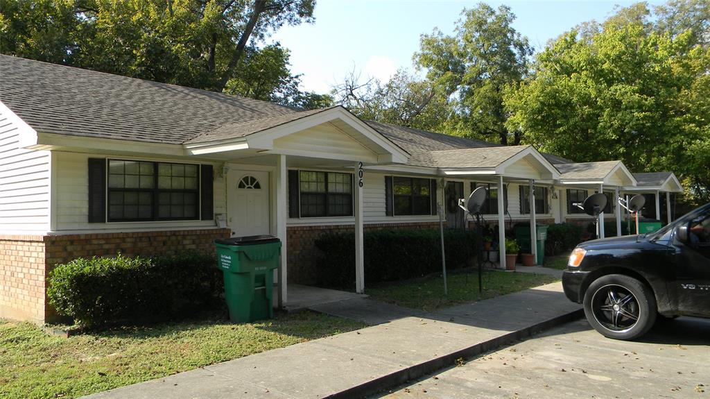 204 2nd Street Gainesville, TX 76240 - Photo 1 of 1 a front view of a house with a garden