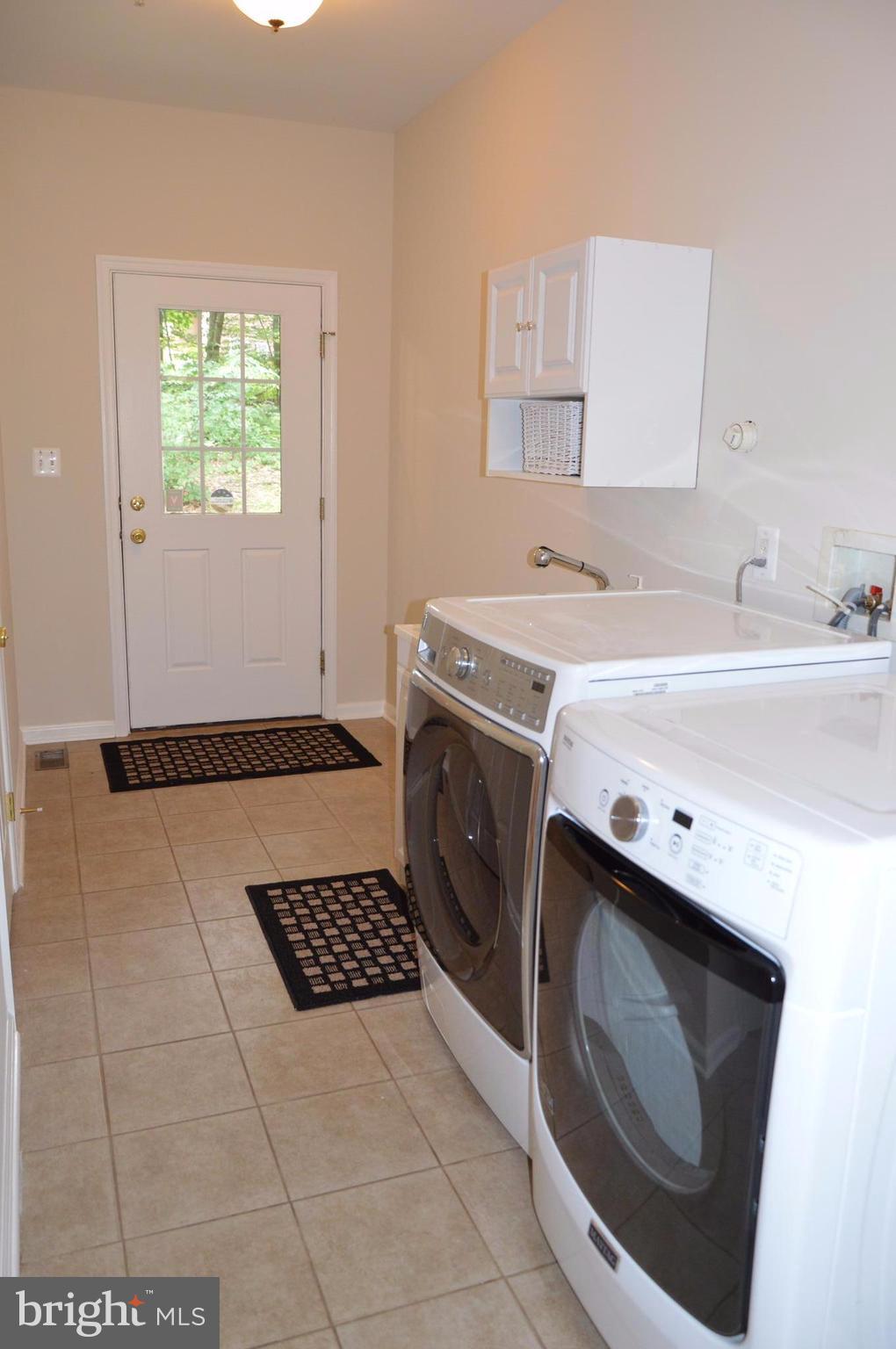 7536 Talbot Run Road Mount Airy, MD 21771 - Photo 14 of 22 a utility room with cabinets washer and dryer