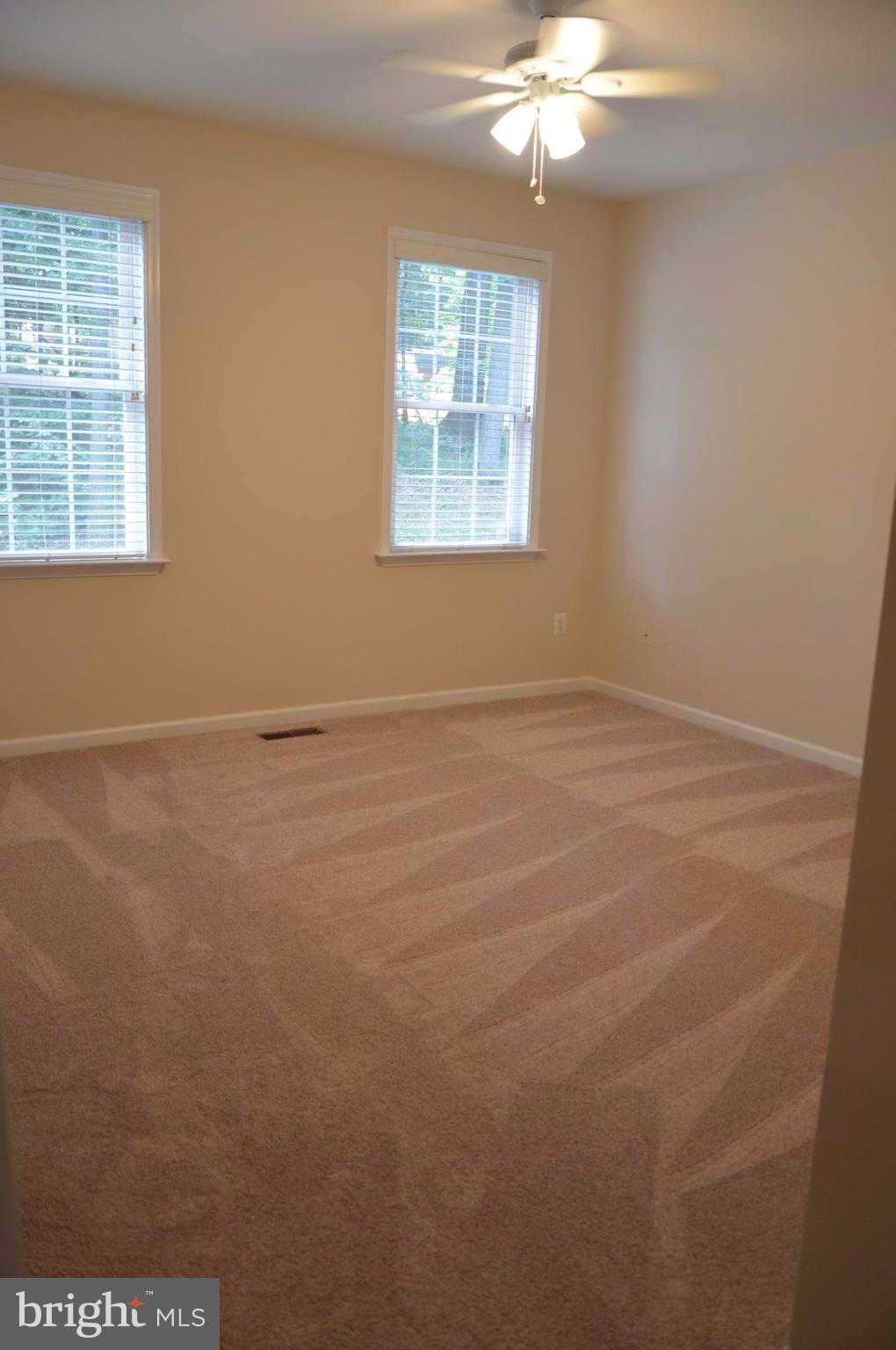 7536 Talbot Run Road Mount Airy, MD 21771 - Photo 6 of 22 an empty room with windows and chandelier fan