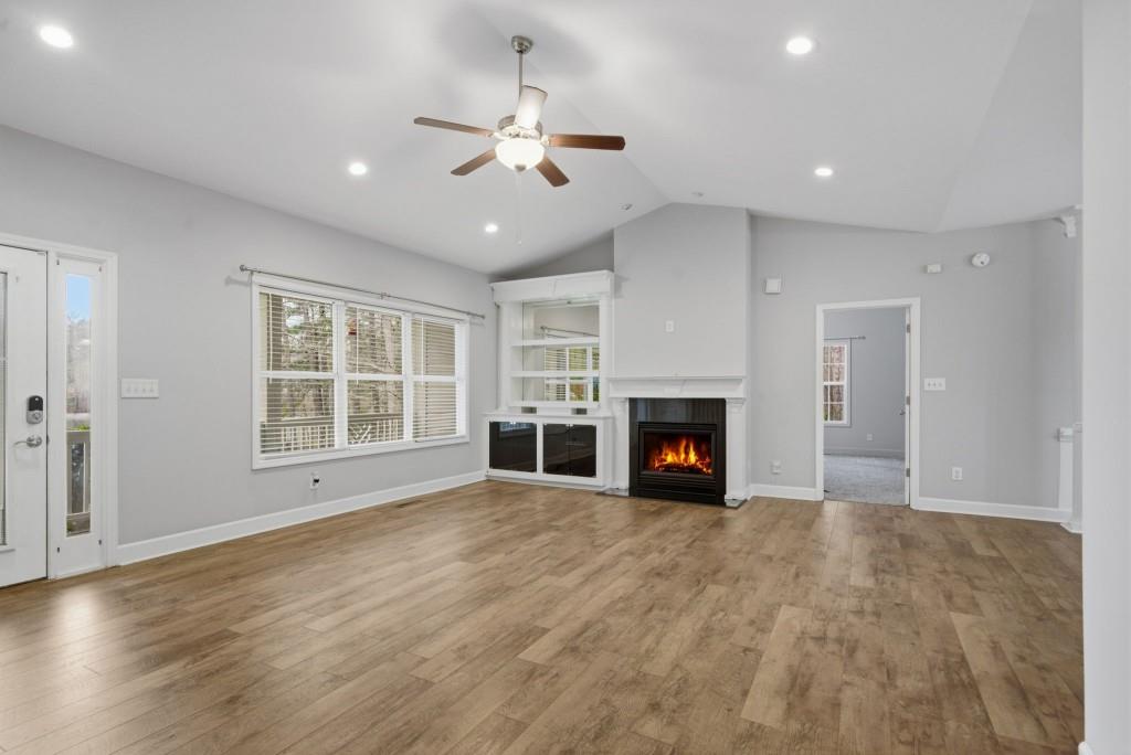 42 Nate Trail Dallas, GA 30157 - Photo 11 of 67 a view of an empty room with wooden floor fireplace and a window
