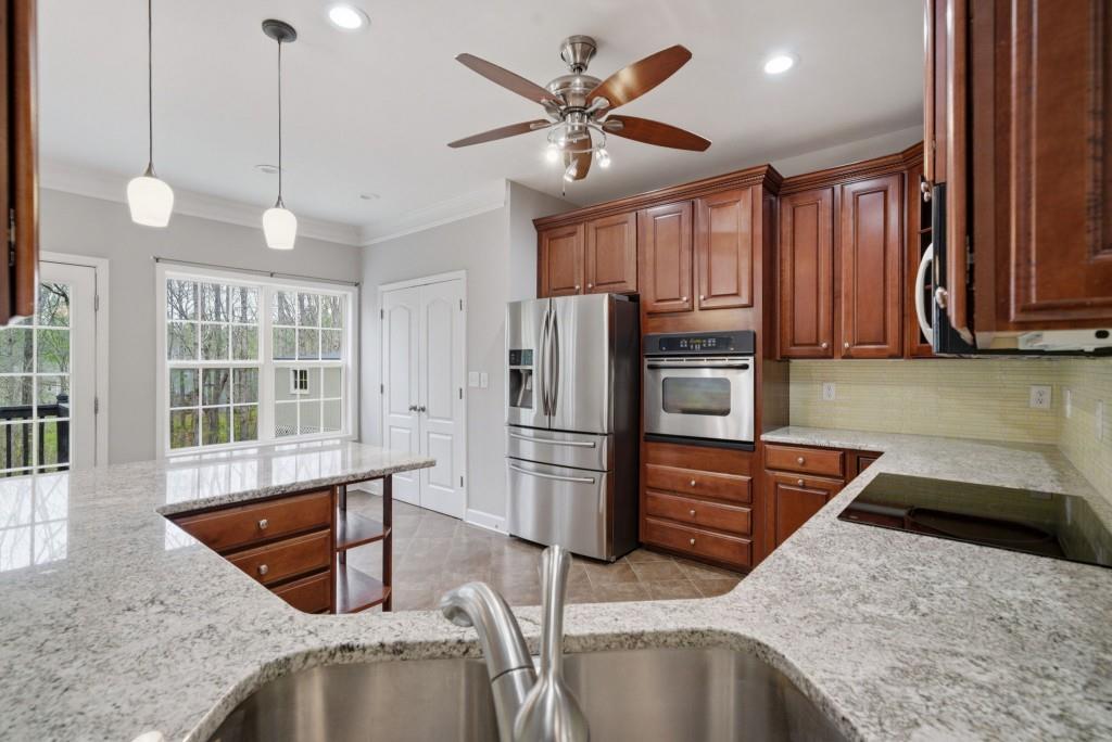 42 Nate Trail Dallas, GA 30157 - Photo 21 of 67 a kitchen with stainless steel appliances granite countertop a sink refrigerator and microwave