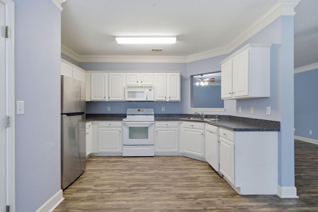 42 Nate Trail Dallas, GA 30157 - Photo 41 of 67 a kitchen with granite countertop white cabinets and white appliances