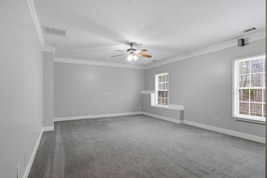 42 Nate Trail Dallas, GA 30157 - Photo 42 of 67 an empty room with windows and chandelier fan