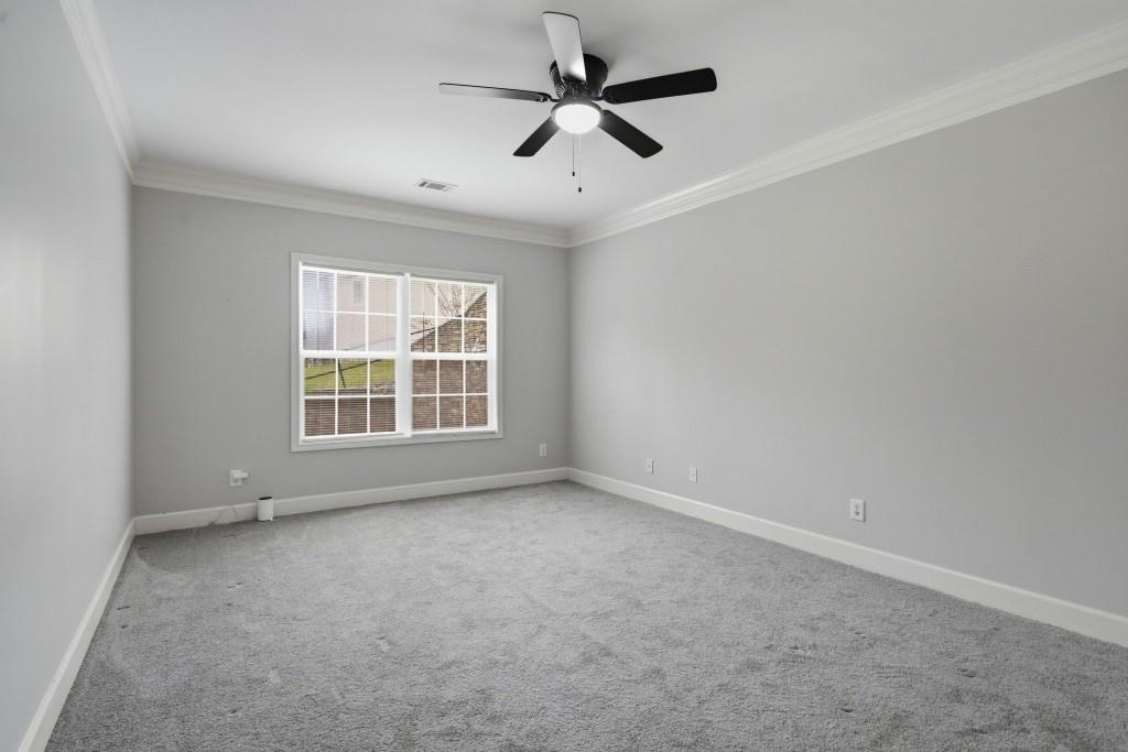 42 Nate Trail Dallas, GA 30157 - Photo 45 of 67 an empty room with ceiling fan and windows