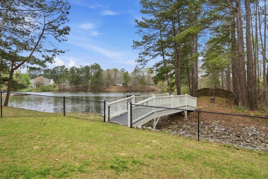 42 Nate Trail Dallas, GA 30157 - Photo 54 of 67 a view of a lake with a bench and trees