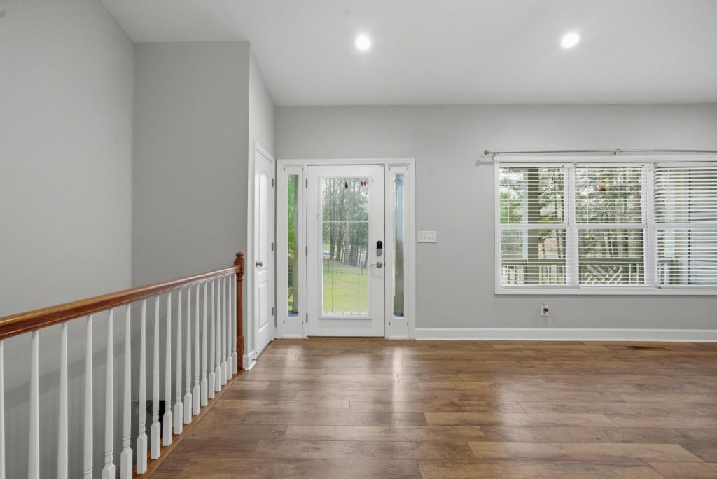 42 Nate Trail Dallas, GA 30157 - Photo 8 of 67 a view of an empty room with wooden floor and a window