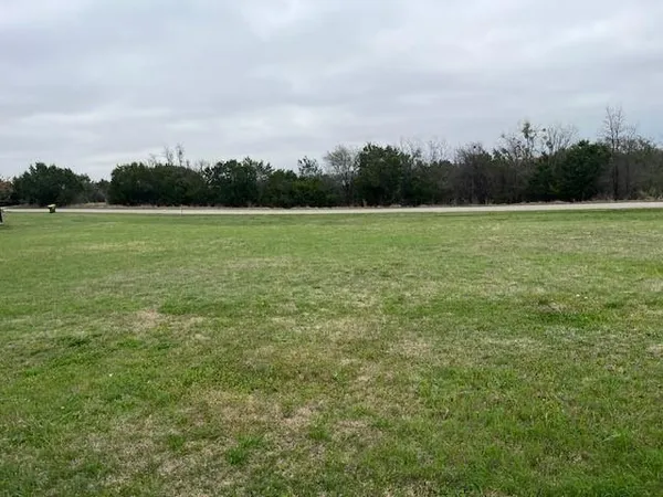a view of outdoor space with field and trees