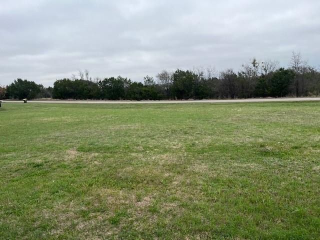 a view of outdoor space with field and trees