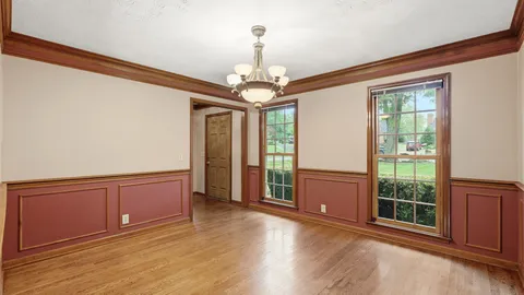 a view of a livingroom with wooden floor and a window