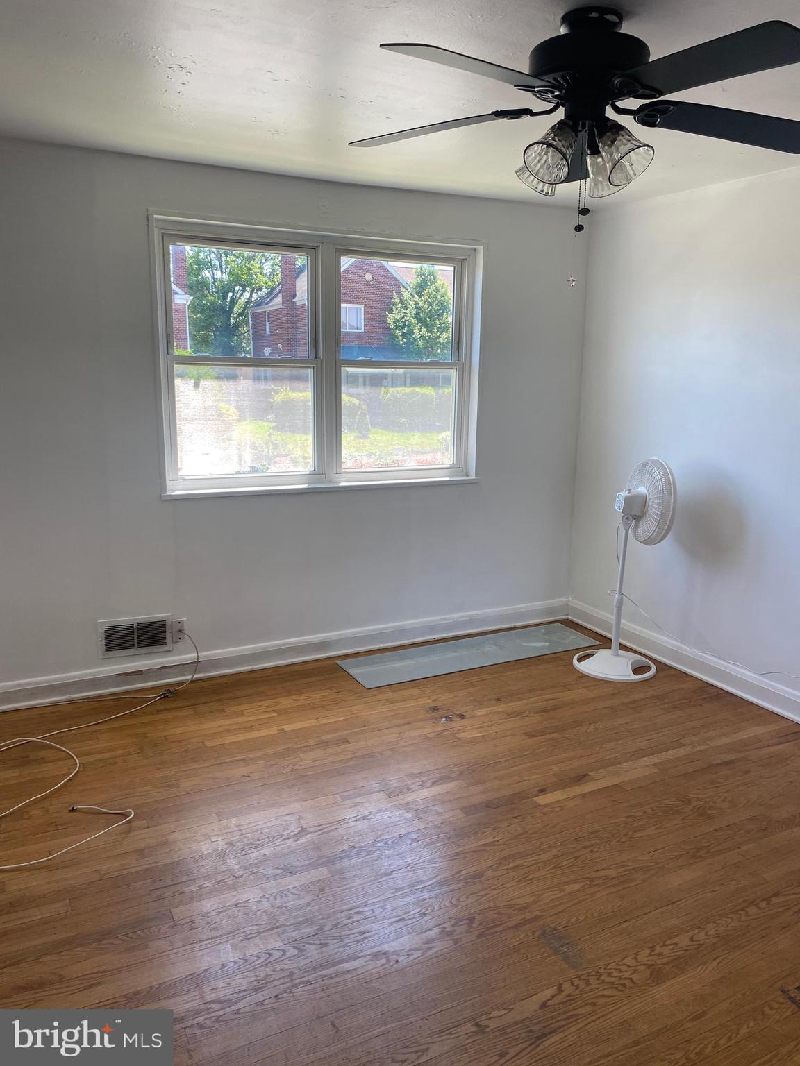 906 Masefield Road Baltimore, MD 21207 - Photo 7 of 22 a view of a room with wooden floor and window