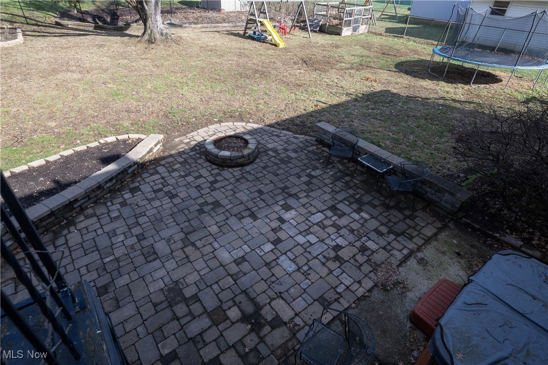 3721 20th Street Northwest Canton, OH 44708 - Photo 38 of 47 View of yard with a playground, a patio, a trampoline, and a fire pit