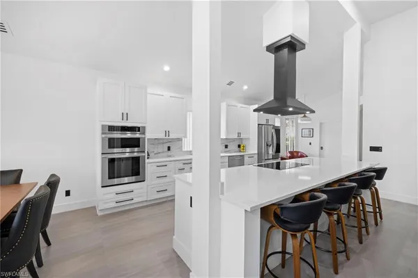 a view of a kitchen with dining table and chairs