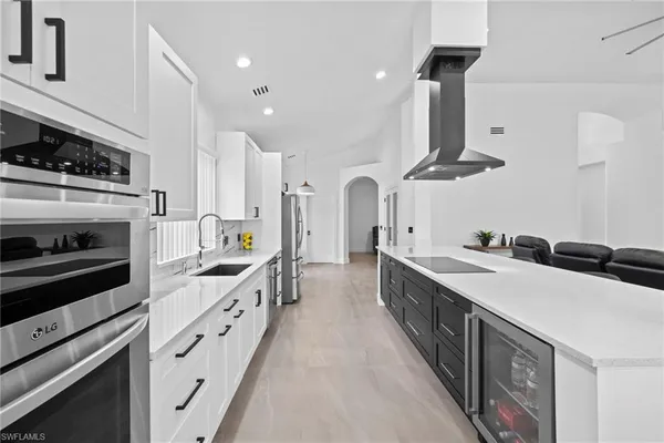 a kitchen with stainless steel appliances a sink stove and cabinets
