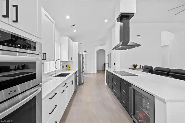 a kitchen with stainless steel appliances a sink stove and cabinets