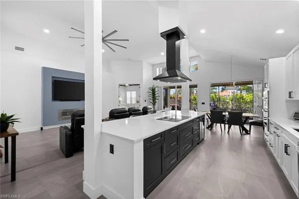 a large kitchen with a table and chairs